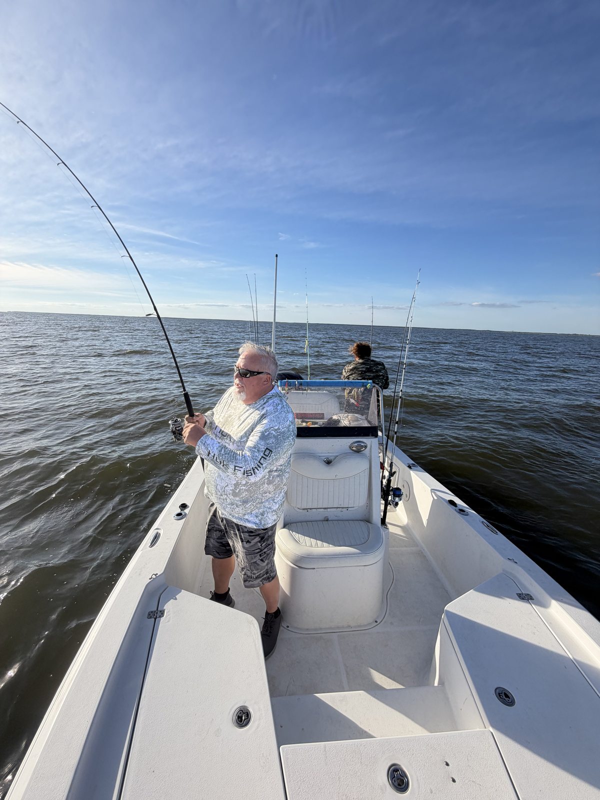 Guest fishing aboard a Champs Coastal Charters boat